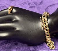 Ring and bracelet shown on display hand