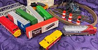 Overview of locomotives, boxcars, track, bridge, transformer, accessories