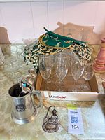 Overall lot showing glassware, pewter tankard, napkins and bottle tag
