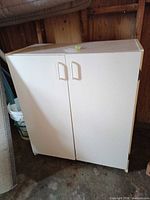 Front view of white cabinet with closed doors