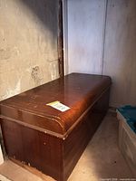 full view of cedar chest with curved lid, showing overall form