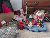 Overview of assorted Christmas décor items on and around blue tote lid