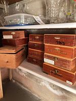 Stacked Corona Grande cigar boxes beside wine box on shelf