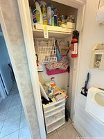 Full closet view showing drawer cart, cleaning products, tools and fire extinguisher