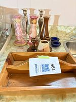 Lot overview showing wooden tray and various candle holders