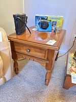 front view of wooden end table with contents on top