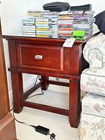 End table front view showing drawer and stretcher base