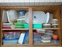 Cabinet filled with numerous plastic containers in two sections