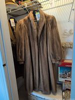 Front view of full-length mink coat hanging