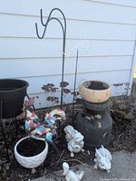 Full lot showing milk can, wooden bowl, shepherd hooks, ceramic planter, two bunny statues