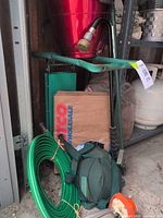 overall lot showing kneeler bench, red planter, hose, knee pads, weeder tool and other items