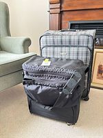 Front view of London Fog suitcase and black carry bag