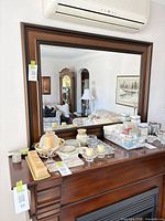 Full view of mirror on wall above mantel