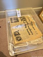 Tote containing stack of old newspapers