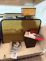 Closed yellow-brown Bernina sewing machine case, wood accessory box, thread spools bag