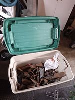 Closed and open view of Rubbermaid tote showing quantity of vintage tools inside
