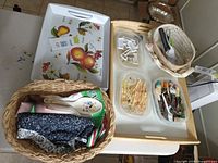 Overview showing wooden tray, wicker baskets, melamine trays, utensil containers and apron fabric