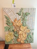 Front view of raised floral relief wall plaque