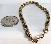 Bracelet beside coin showing scale and clasp