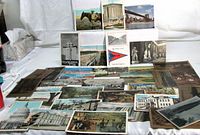 Group shot all 33 postcards spread on table