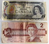 Front view of 1973 $1 and 1986 $2 Canadian banknotes