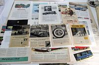 Overall view of assorted vintage auto ad pages spread out