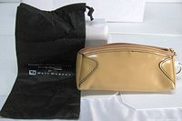 Pouch and dust bag front view showing color, material and branding