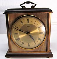 Front view of Metamec mantel clock showing dial, case and handle