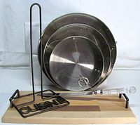 All items grouped: stainless tiers nested, paper towel holder, bread board, knife