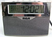 Front view showing LCD display at 12:02