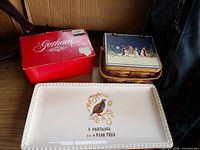 Gorham box, wicker recipe basket with snowman lid, Magenta partridge serving tray on shelf