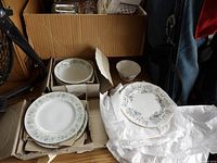 Box containing Haviland plates and bowls, Royal Albert plates visible