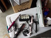 Overview of all hair styling tools and case on table