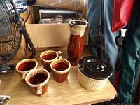 Full lot showing four mugs, vase, covered dish