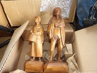 Two carved wood figurines in box