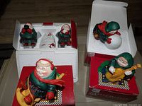 Overview of all six Merry Makers figurines with some original boxes