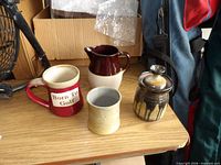 Overview of four pottery items on table