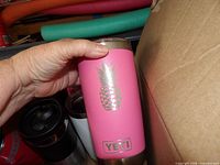 Pink Yeti tumbler with pineapple graphic held in hand