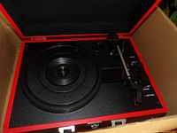 Open Victrola suitcase turntable showing platter and controls