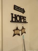 Arrow plaque, HOPE sign, Faith and Dream star plaques hanging on wall