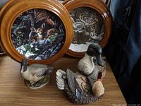 Overall lot showing two framed plates and three bird figurines