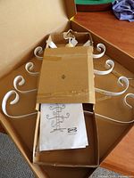 Boxed IKEA VINTERFINT ornament tree components showing white metal scroll branches and packaging
