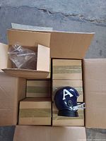 Open shipping box showing taped individual radio boxes and one helmet radio on display