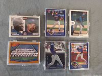 Fronts of six representative cards including Delgado/Wells combo, Roy Halladay, Blue Jays team photo, Joe Carter, Eric Hinske and another player