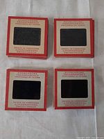 Stacks of red-border Kodachrome slide mounts, top view