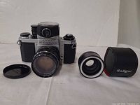 Camera body with attached lens, Soligor tele converter, converter case, lens cap