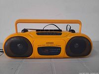 Front view showing speakers, cassette slot, branding