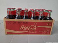 Front view of crate showing Coca-Cola Classic branding and 24 bottles