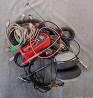 Assortment showing multimeter, headphones, cables, microphones, antenna