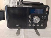 Front view of Eton Grundig Edition Field radio showing speaker, display, controls and eton and Grundig branding